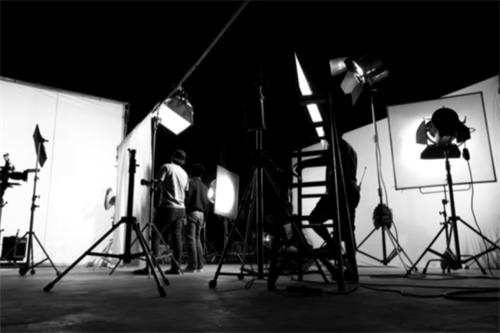 alt="Crew setting up lighting in a photography studio"