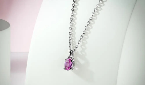 alt="Jewelry product photo of a pink sapphire pendant"