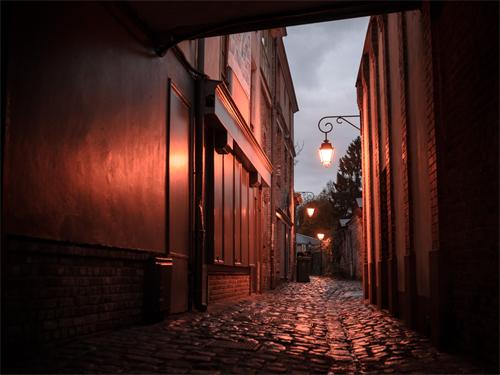 alt="Old town alley at twilight"